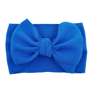 Detail of royal blue bow headband with high-elastic textured fabric for infants