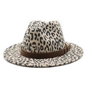 Detailed close-up of leopard print fedora hat with brown leather band and visible stitching