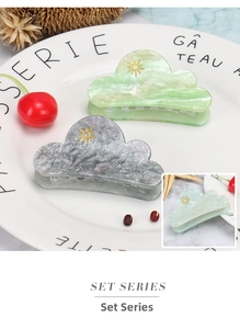 Detailed set of two cloud-shaped hair clips with marble texture and gold sun charm decoration