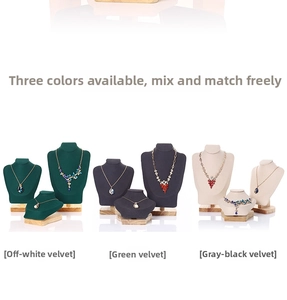 Detailed view of suede and wood jewelry display bust set in beige green and black