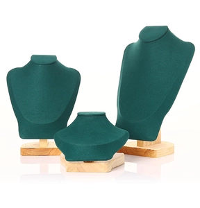 Three-piece dark green velvet necklace busts with premium wooden bases in varied heights