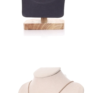 Detail of velvet portrait necklace display with a gold chain and solid wood base support