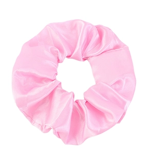 Close-up of pink satin hair scrunchie showing soft fabric texture and elegant pleats