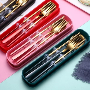 Close-up of portable stainless steel cutlery sets in black red pink and green colors