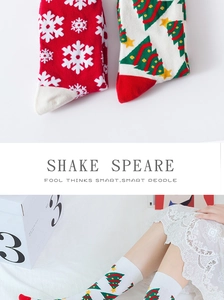 Detailed knit pattern of red snowflake and white Christmas tree holiday mid-calf socks