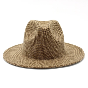 Macro detail of brown houndstooth wool fabric and brim on a classic fedora hat