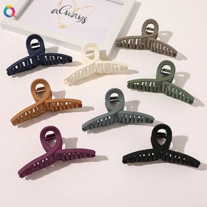 Matte finish large hair claws set in 8 neutral colors showing sleek cross-ring handle design