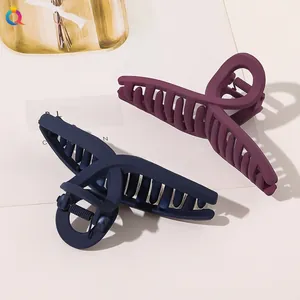 Detail of large matte hair claws in dark purple and navy blue with strong metal springs