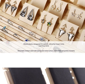 Detailed view of bamboo jewelry display tray with velvet slots for rings and earrings