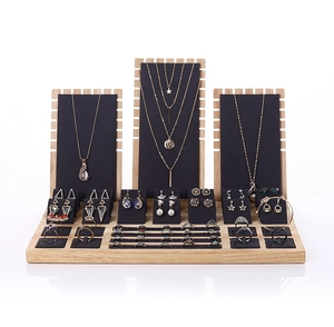 Detail of wooden jewelry display set with black fabric panels for necklaces and rings