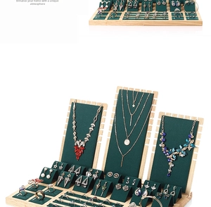 Bamboo jewelry display set with dark green velvet slots for rings and necklaces