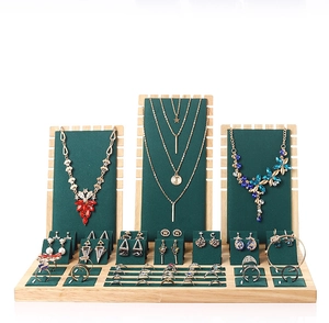 Bamboo and green velvet tiered jewelry display set for necklaces and rings on white background