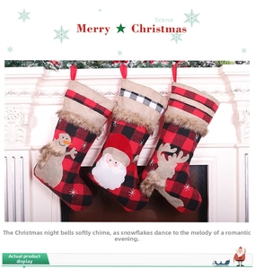 Close-up of three plaid Christmas stockings with Santa, snowman, and reindeer hang on mantel