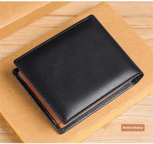 Detail view of men's leather wallet with black exterior and brown interior contrast lining