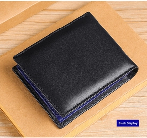 Men's tri-fold leather wallet detail showing black pebbled texture and blue interior lining