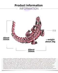 Detailed view of crocodile brooch with pink rhinestones and size dimensions 50x50mm