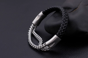 Detail of men's leather braided bracelet with double row stainless steel curb chain