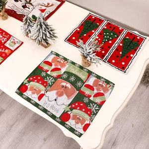 Knitted Christmas placemats with cartoon patterns on a white wooden table backdrop