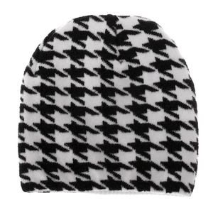 Detail of knitted beanie showing high-quality black and white houndstooth pattern texture