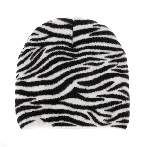Detailed close-up of heavy knit zebra stripe beanie in warm black and white fuzzy yarn