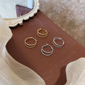 Exaggerated geometric twisted double hoop earrings in gold and silver finish