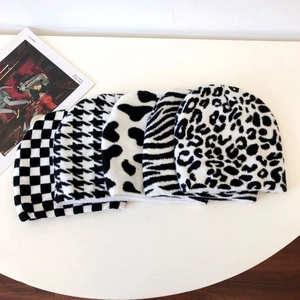 Fashionable knitted beanies in black and white cow, zebra, and leopard patterns