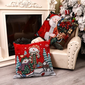 Christmas snowman and Santa Claus jacquard cushion covers set on a cozy chair