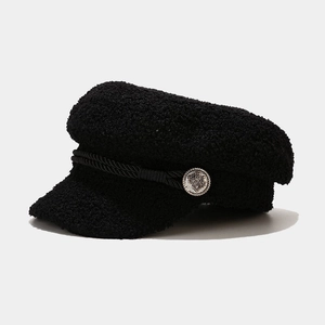 Detail of black newsboy cap texture with twisted rope and vintage silver metal button
