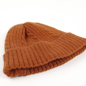 Detail view of the caramel cable knit texture and cuffed hem on this winter beanie hat