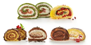 Macro view of sliced Swiss rolls with cream fillings and fresh mint garnishes on white