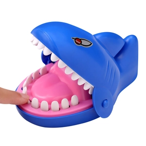 Detail of blue shark biting finger toy showing interactive teeth pressing gameplay