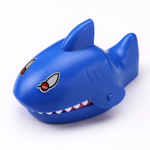 Detail view of a blue plastic toy shark featuring white teeth for a finger biting game