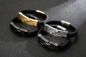 Detail of woven leather bracelets with gold, silver, black, and gunmetal steel clasps