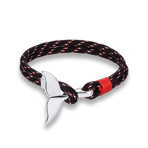 Macro detail of nautical bracelet with whale tail alloy clasp and tricolor woven rope