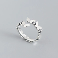 Detailed view of polished S925 sterling silver butterfly ring with adjustable band