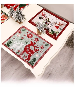 Detail view of jacquard Christmas placemats featuring reindeer and snowman patterns