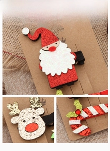 Detail display of glittery Santa, elk, and candy cane hair clips for Christmas styling