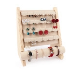 Detail view of wooden jewelry display rack with beige velvet hangers for earrings and watches