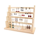Macro detail of the four-tier wooden step earring display stand with smooth wood texture
