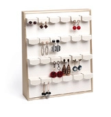 Detail view of a 4-tier wooden earring display stand with tiered slots and white backing