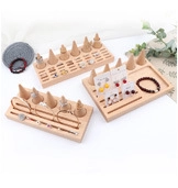 Detail view of wooden jewelry display set with ring cone, earring board and bracelet tray