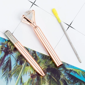 Rose gold diamond ballpoint pen with large crystal cap and refill on palm leaf card