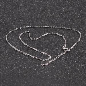 Detail of silver stainless steel chain with lobster clasp on sparkling black background