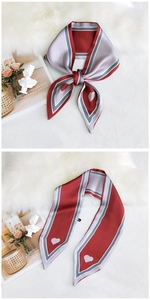 Detailed view of heart-patterned silk scarf styled as a bow and straight tie