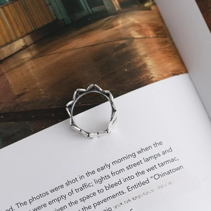 Macro shot of an antique silver S925 sterling silver heart ring on a vintage book page
