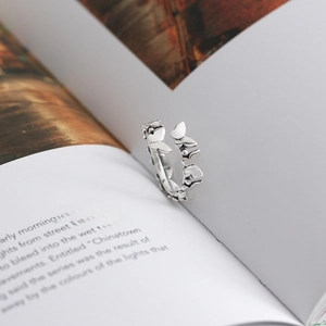 Macro shot of butterfly design S925 sterling silver open ring on a vintage book