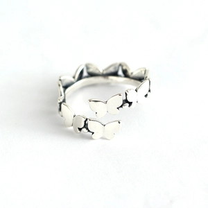 Polished S925 sterling silver butterfly open ring with beaded accents on white background