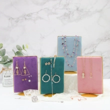 Detailed view of colorful velvet jewelry stands showcasing earrings and necklaces in detail