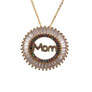 Macro shot of gold MOM pendant with baguette and colorful round cubic zirconia stones