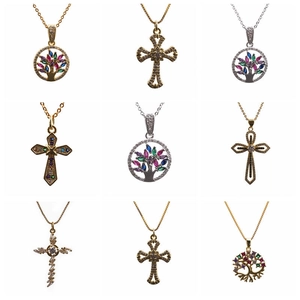 Detailed grid of butterfly, tree of life, and cross pendants with micro-pave zircons